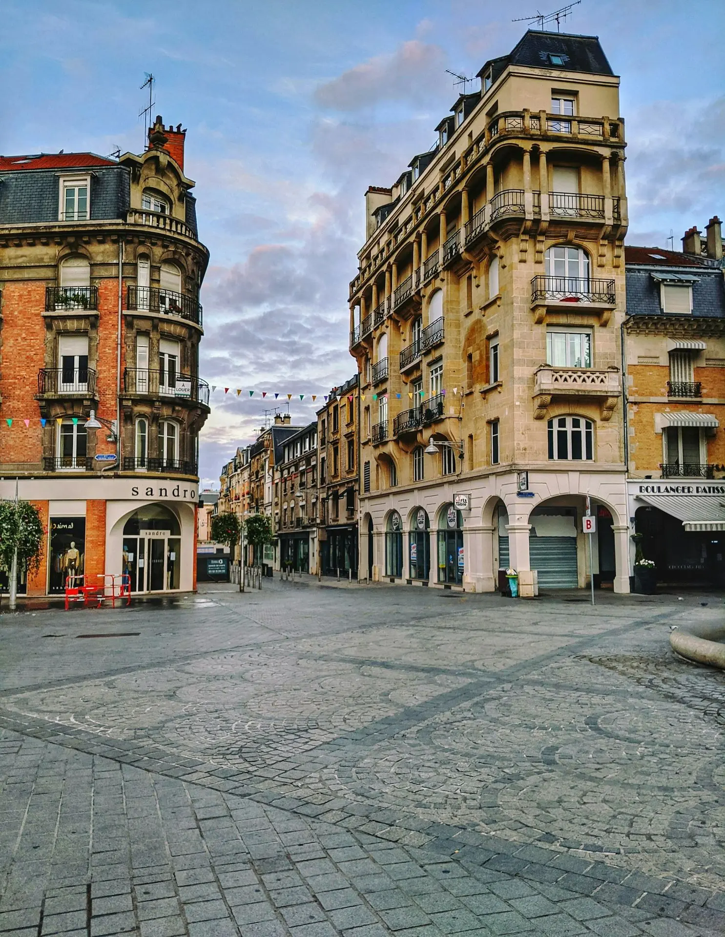 a city square with a clock tower in the middle of it